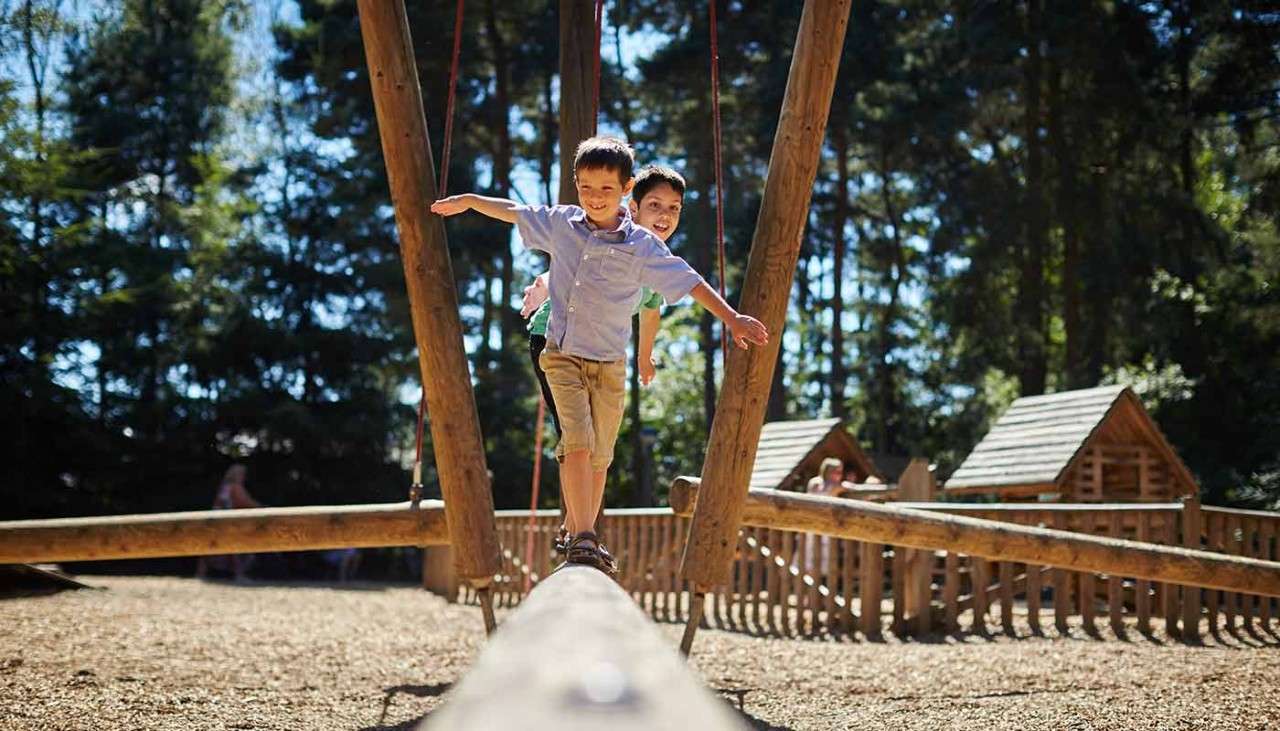 Child playing on balance beam