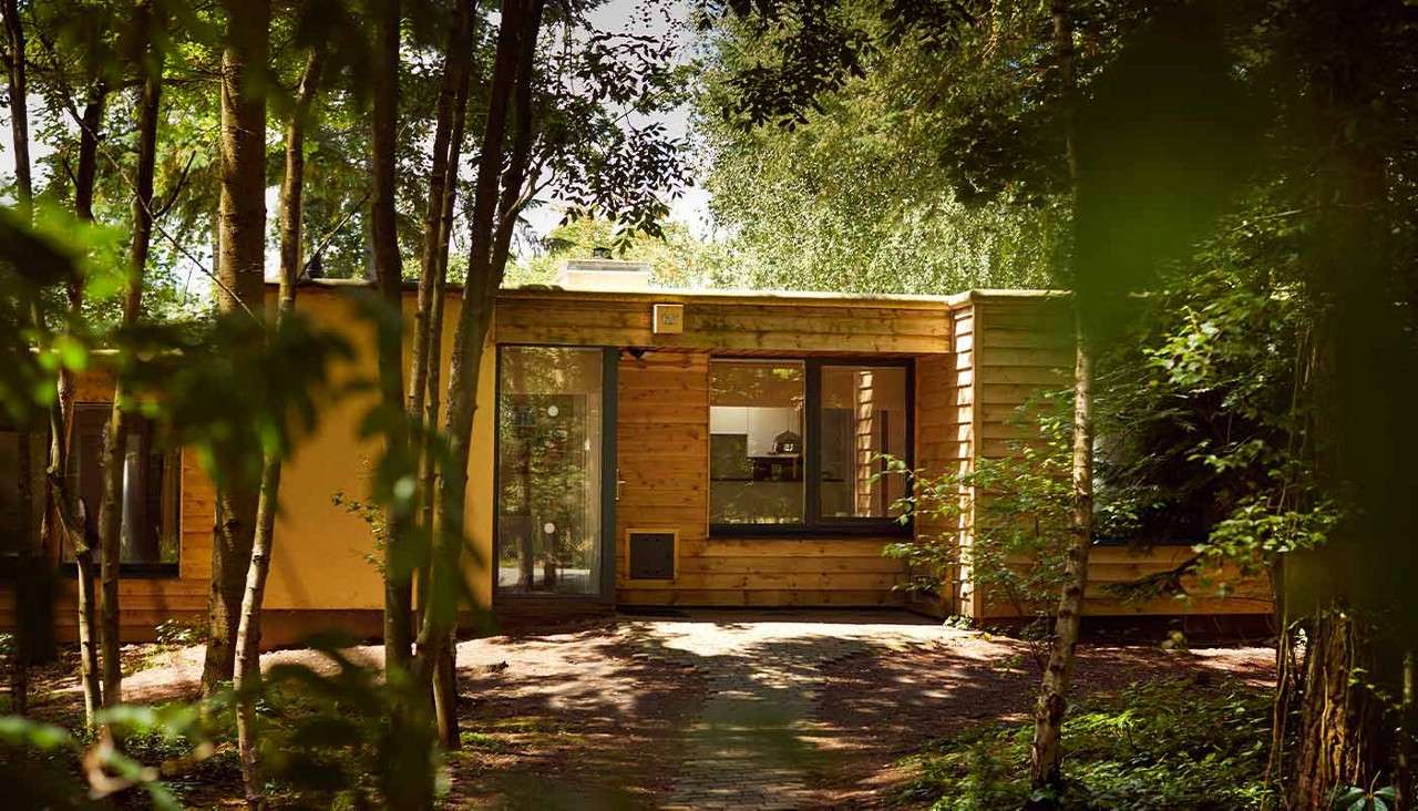 The exterior of a lodge in the forest 
