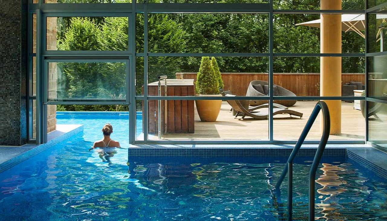 A woman swimming in an indoor pool at Aqua Sana Spa 