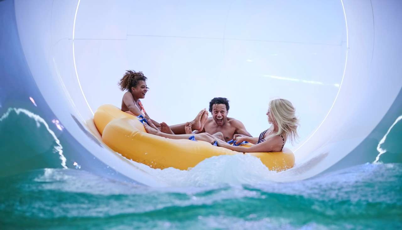 A family on an inflatable in the Tropical Cyclone waterslide