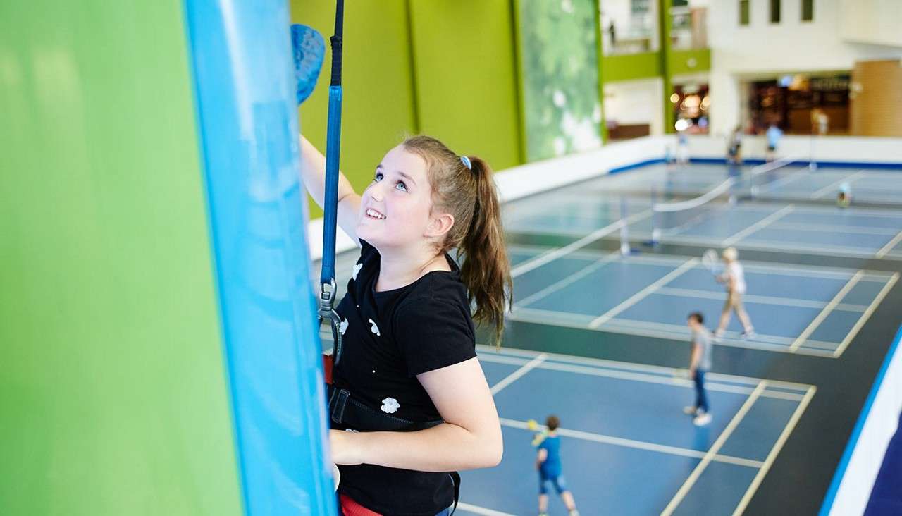 Girl on indoor climbing wall