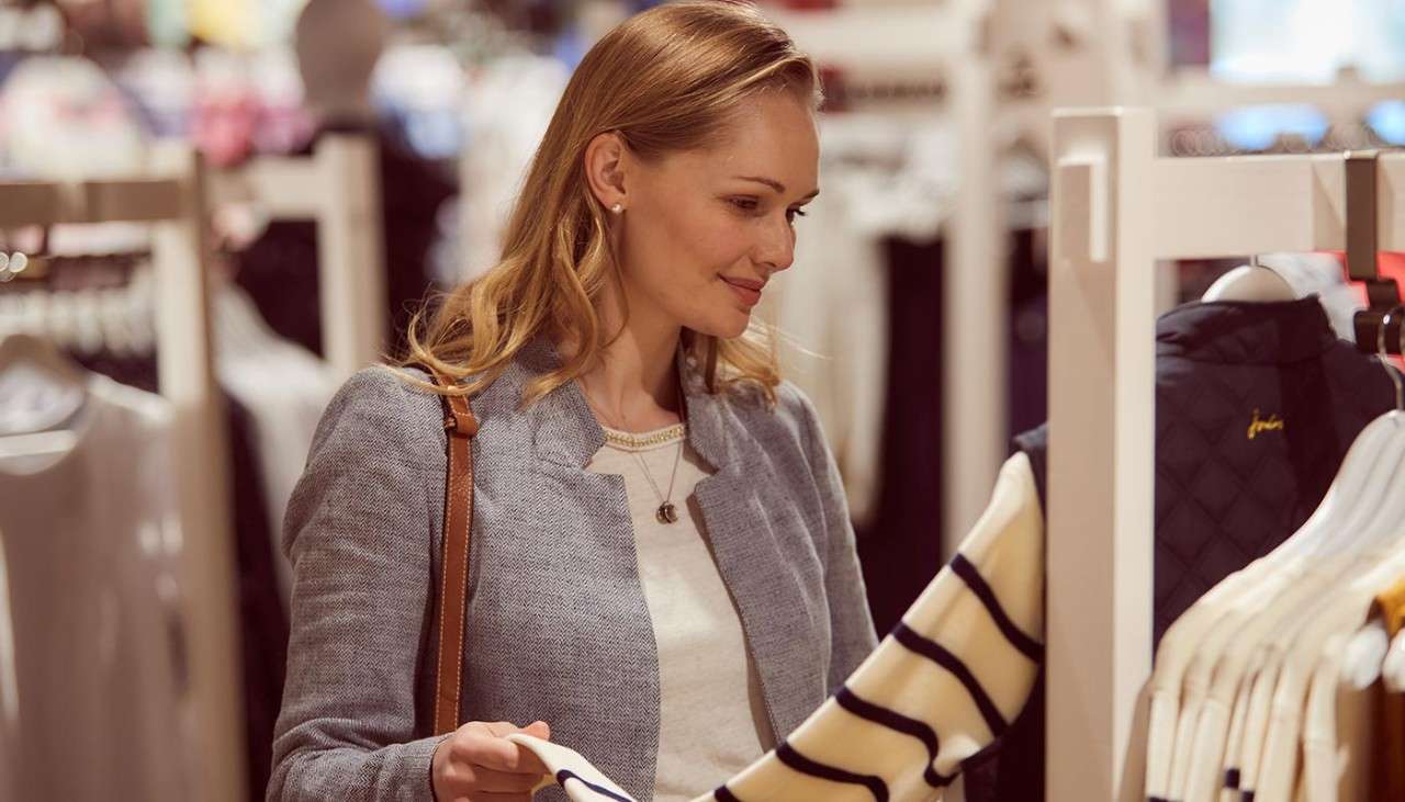 A woman shopping for clothes in a Joules store