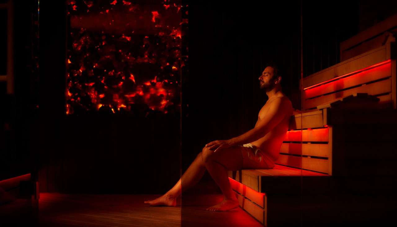 Man sitting inside the Lava Sauna.