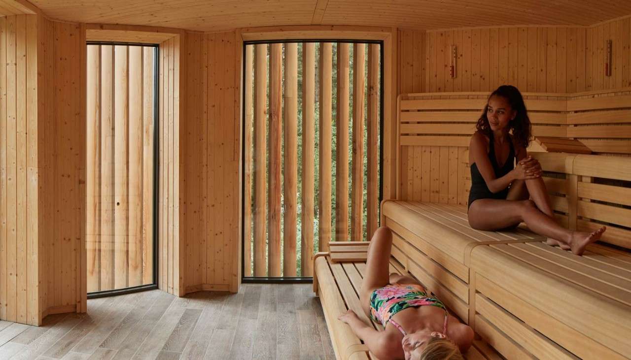 Two ladies resting inside the Treetop Sauna