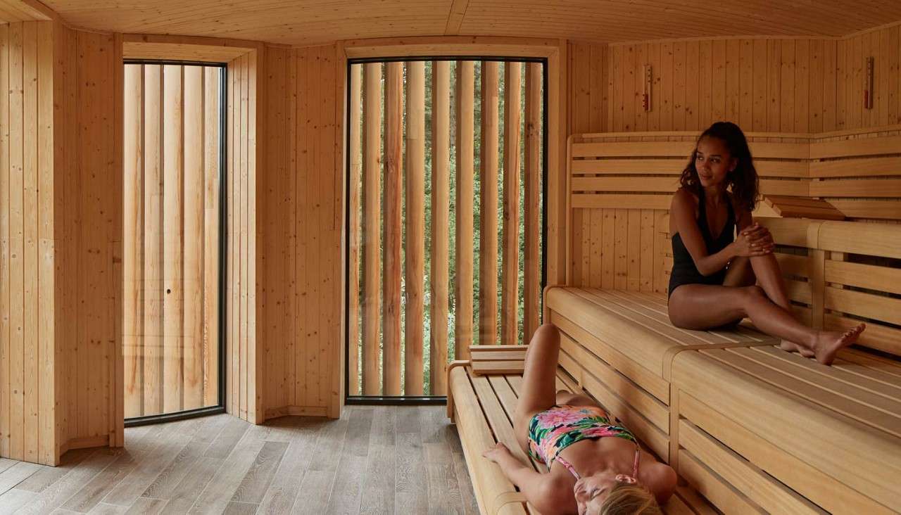 Two ladies resting inside the Treetop Sauna
