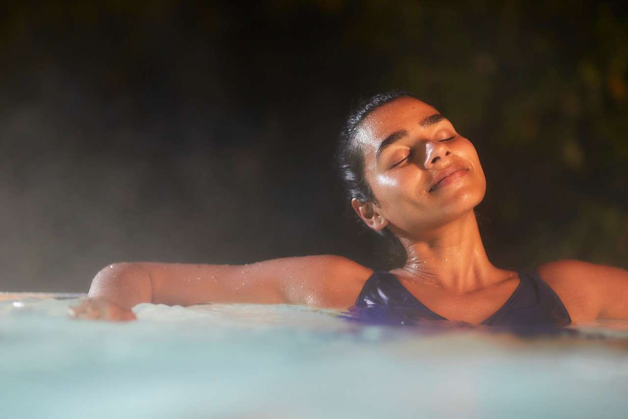 Women leaning on the edge of hottub 