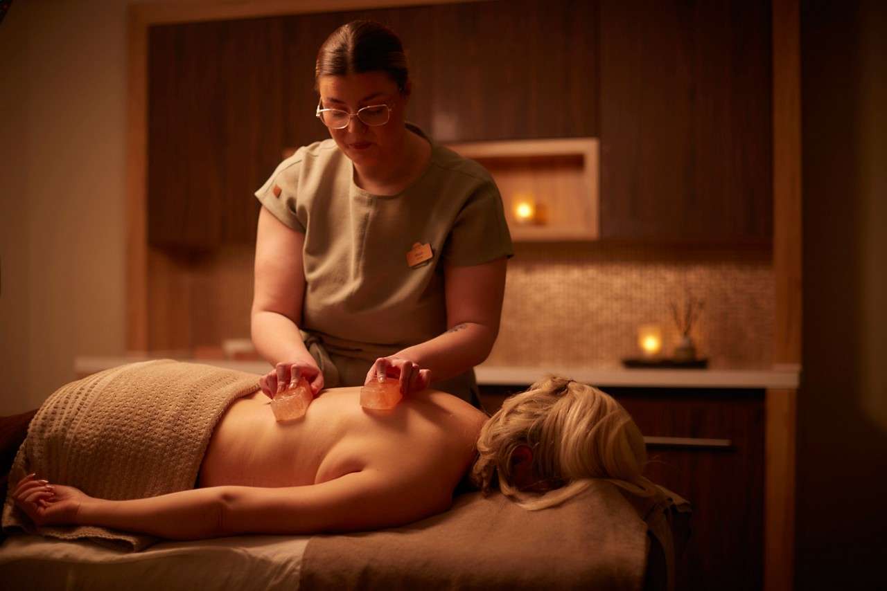 Woman having a face & body treatment.
