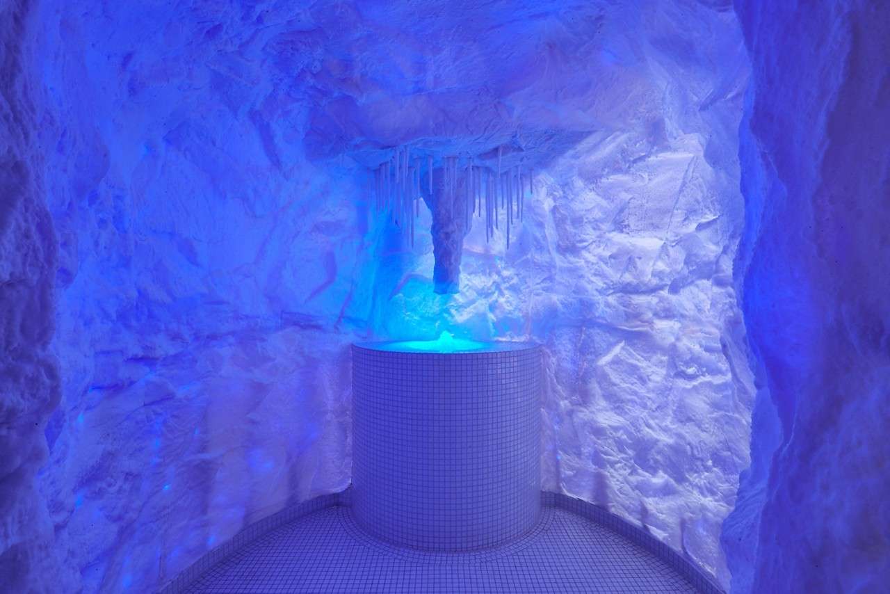 Cold room made of ice with glowing coloured lights.