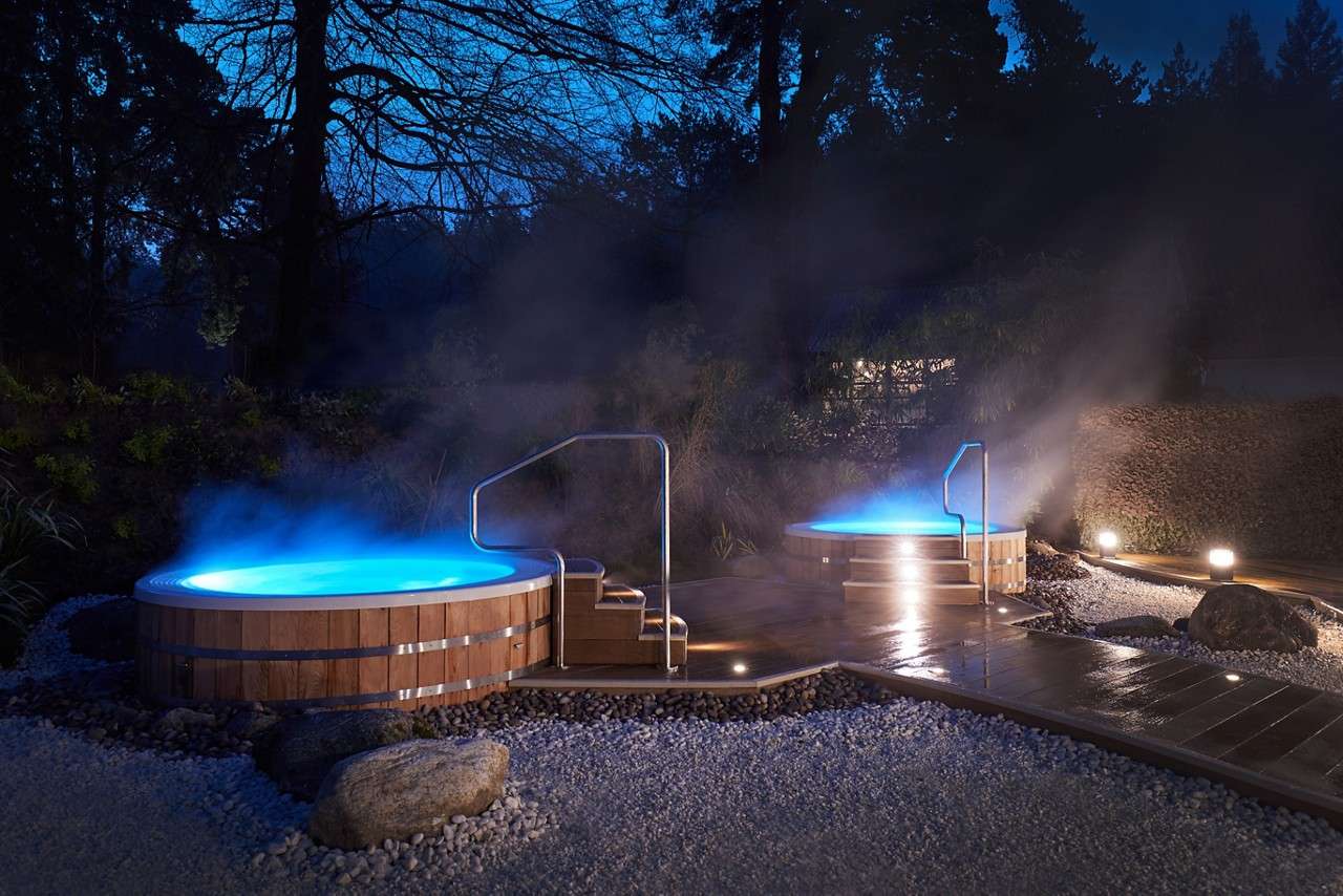 Steaming hot tubs in the Hot Springs Garden at night.