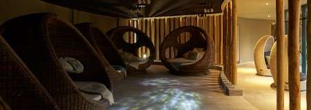 Comfortable egg chairs in a dim lit room.