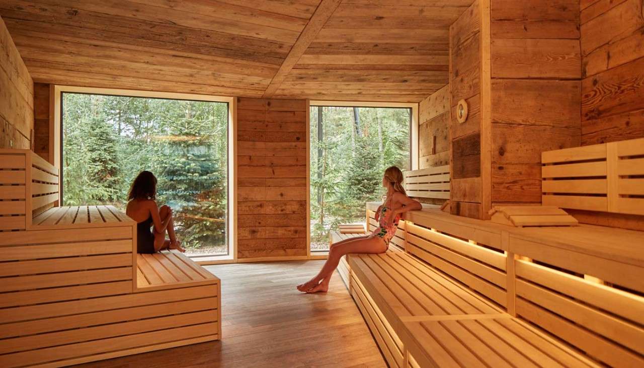 Two woman looking out the window in a Nordic Sauna