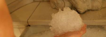 Arm and had holding a ball of chipped ice.