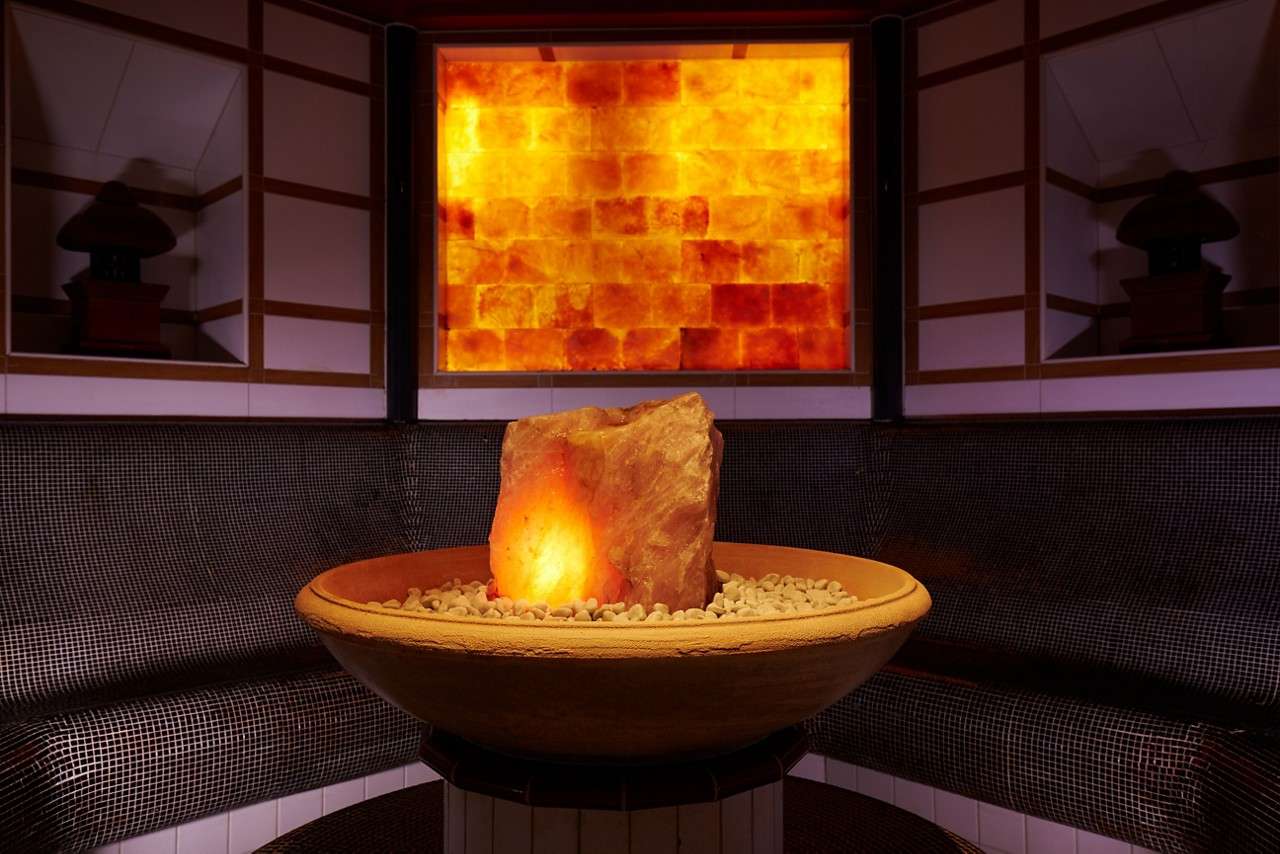 Curved bench seating around a glowing salt centrepiece.