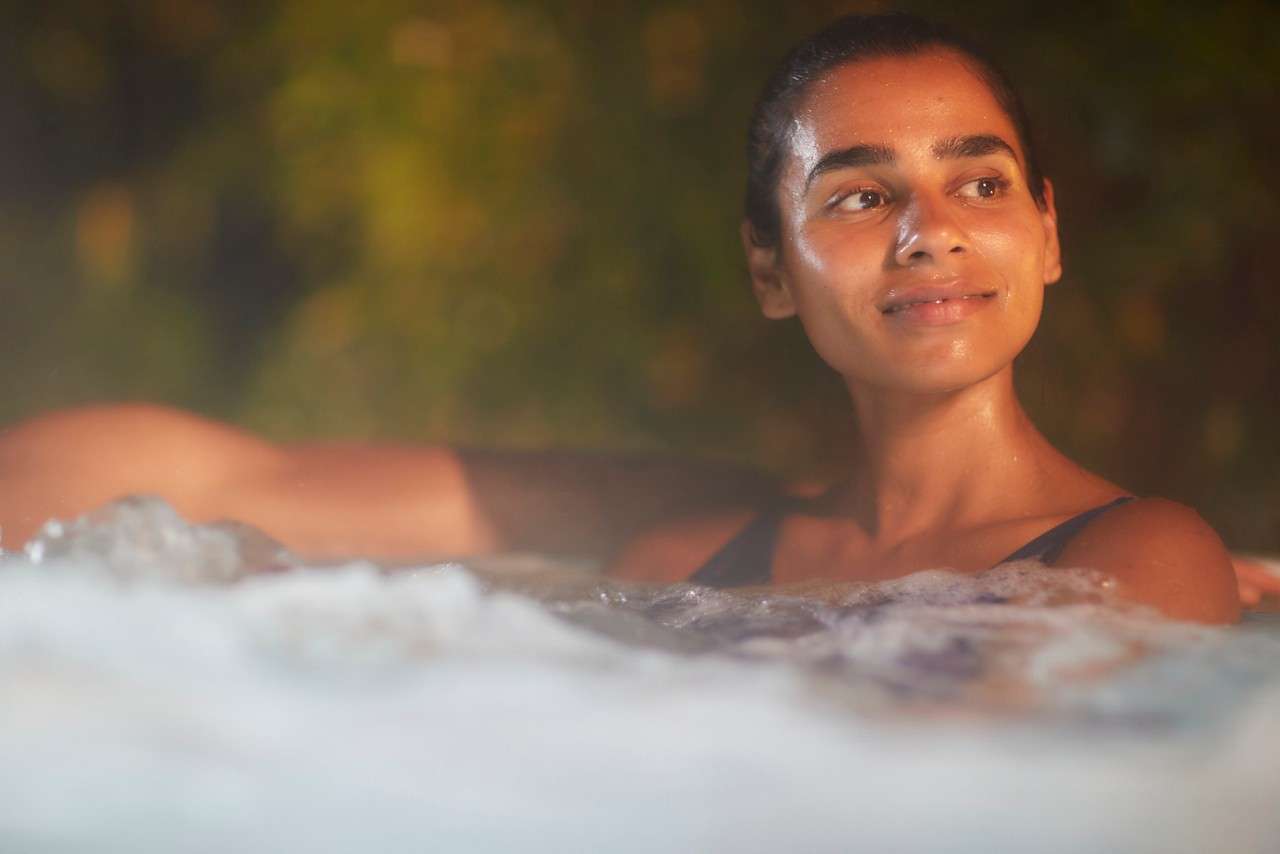 Women leaning on the edge of hottub 