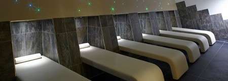 Loungers lined in a room with small lights.