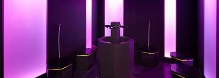 Glowing room with seating and a central fountain.