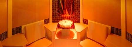 Ambient room with seating and central bowl of herbs.