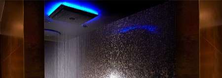 Square rainfall shower backlit with blue LED lights.