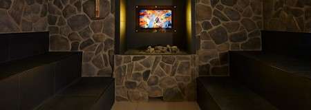 Inside a dim lit stone covered sauna.