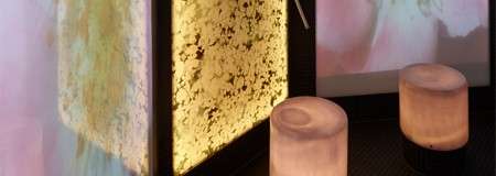 Pretty floral displays set behind glowing stools.