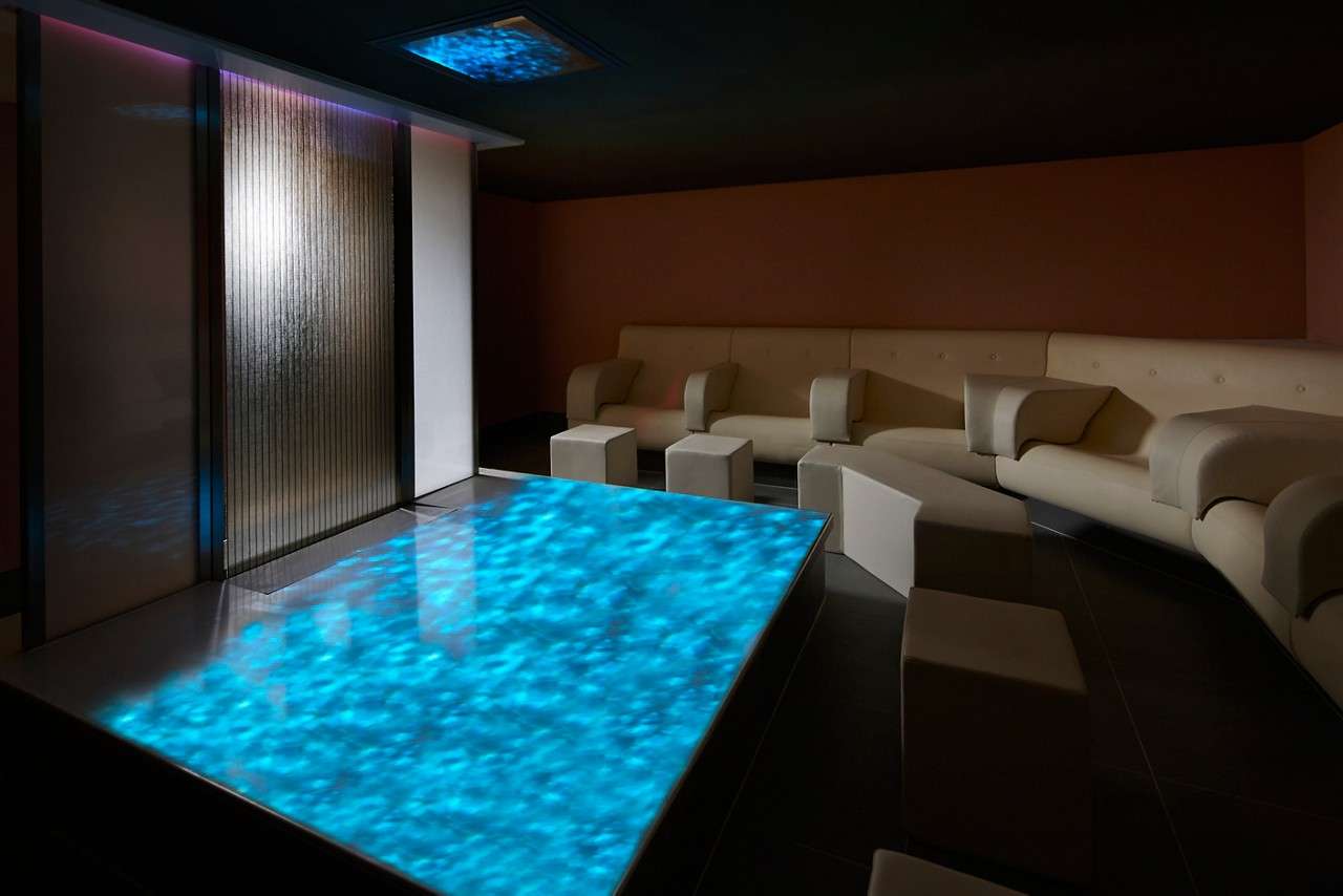 Meditation room with water patterns projected on a table.