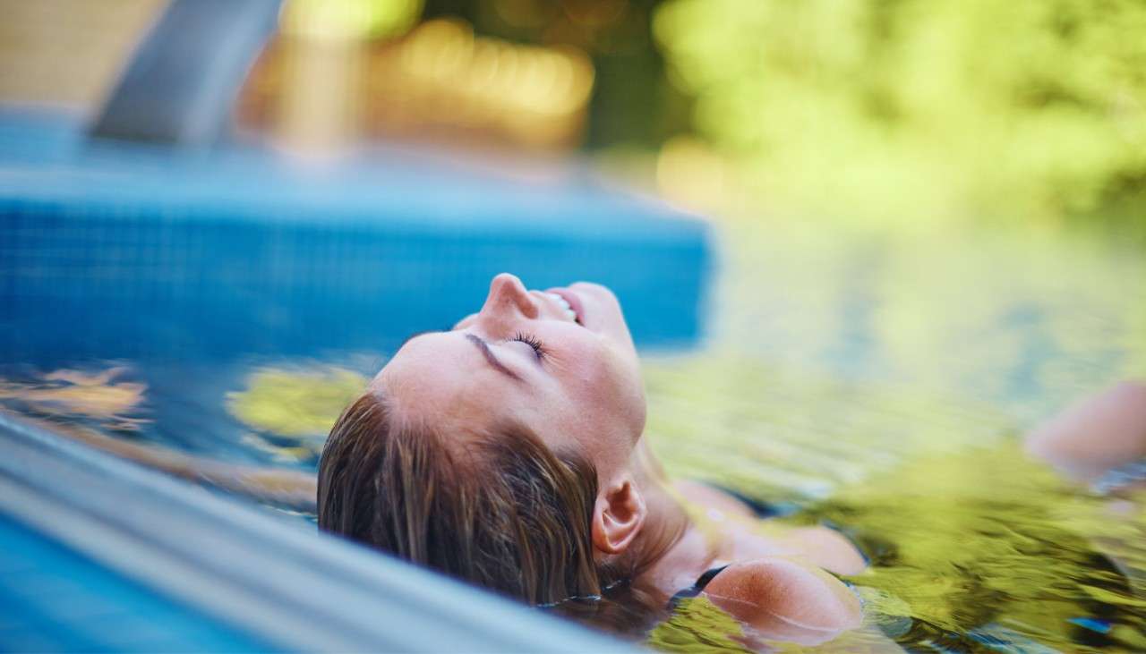 Woman soaking in an Outdoor Pool