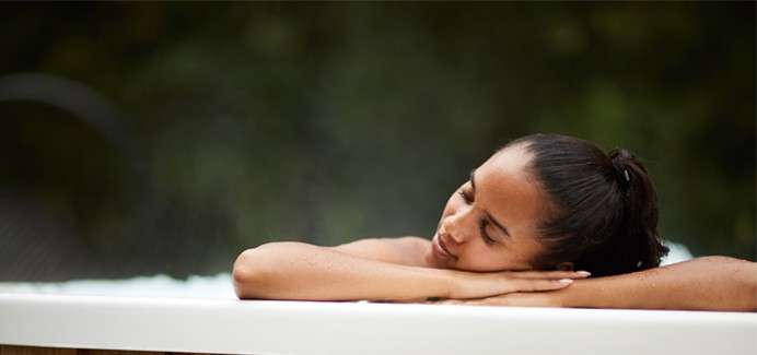 Women leaning on the edge of hottub 