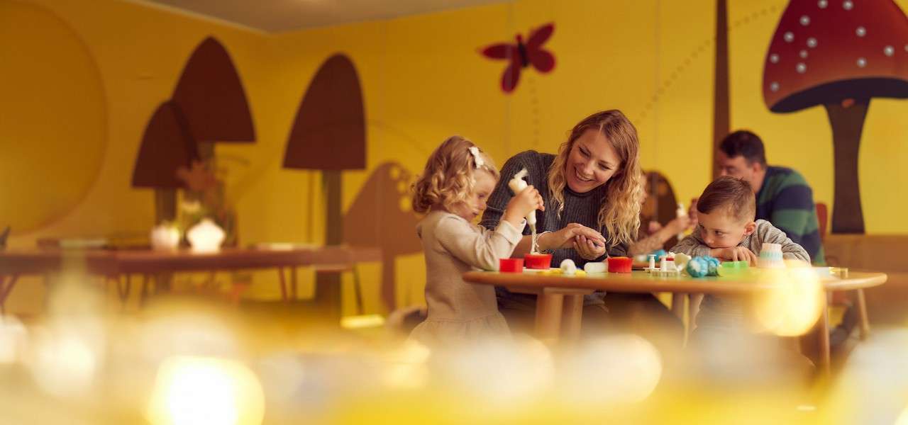 A mother making cupcakes with her children.