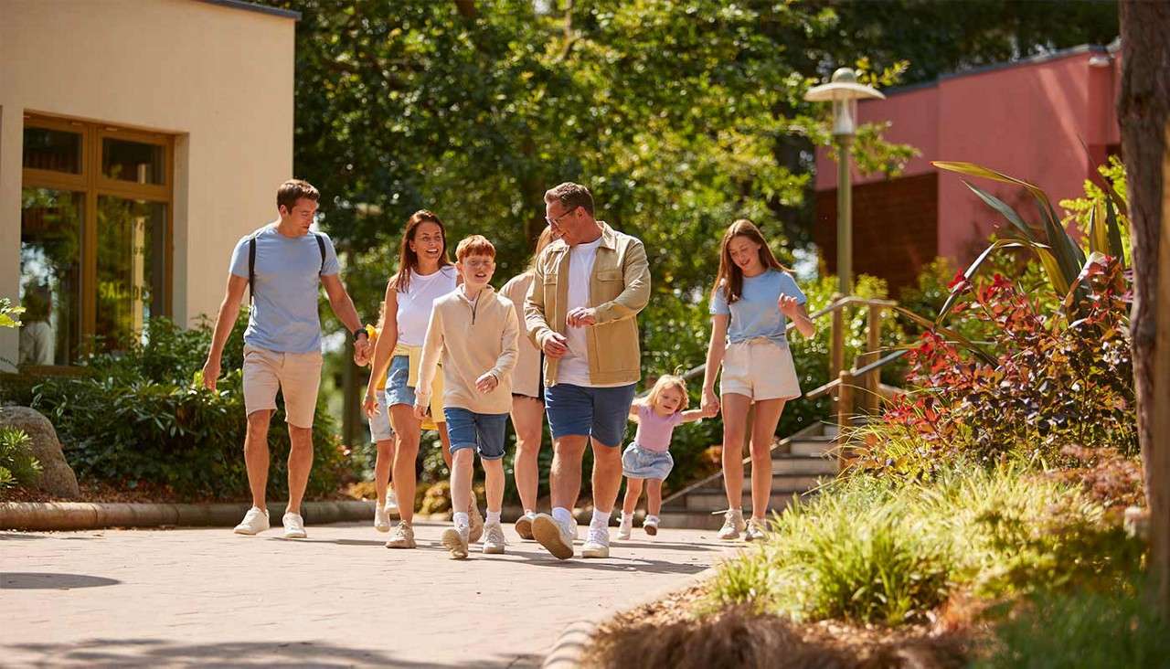 A large family walking through the village square together.