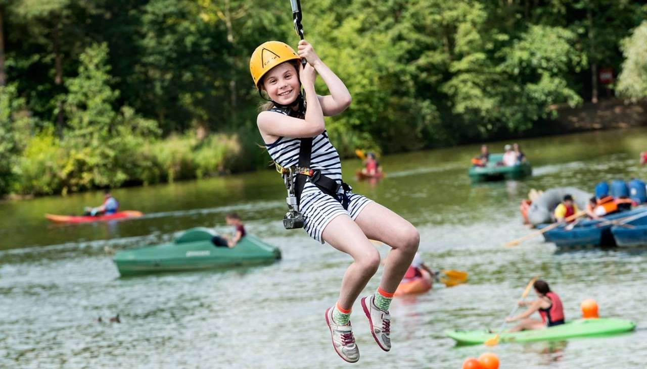 Child on the zip wire across the lake