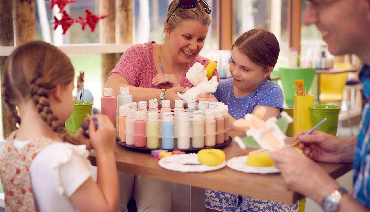 Family taking part in pottery painting