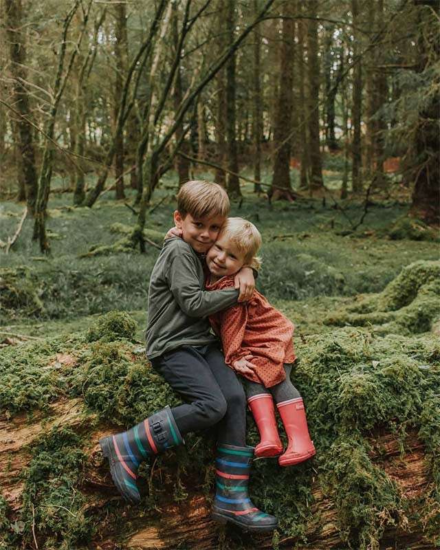 Two children sat in the forest