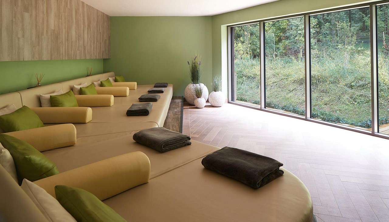 A bed in a serene looking room, the Aqua Sana Forest Spa relaxation room 
