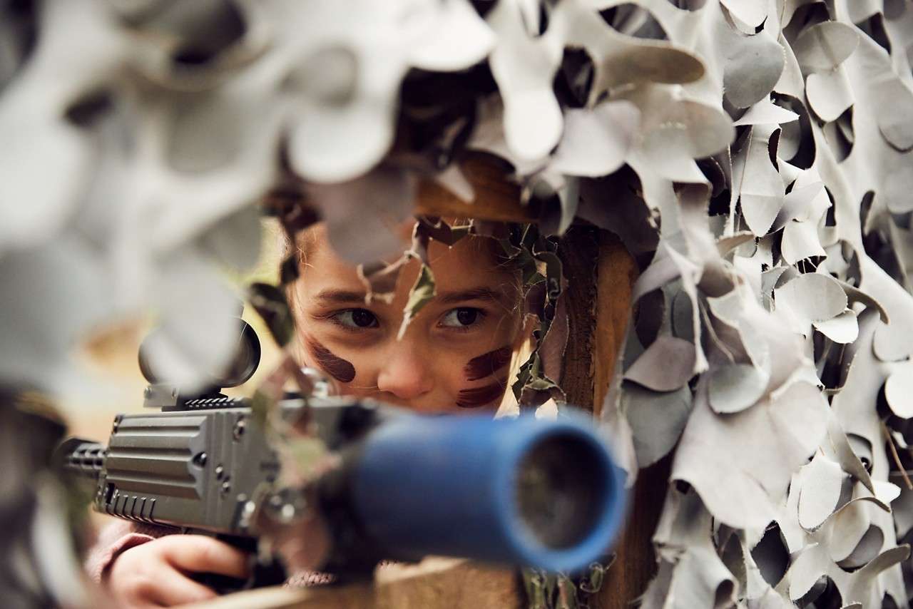 A lady camoflauged while taking part in Laser Shock