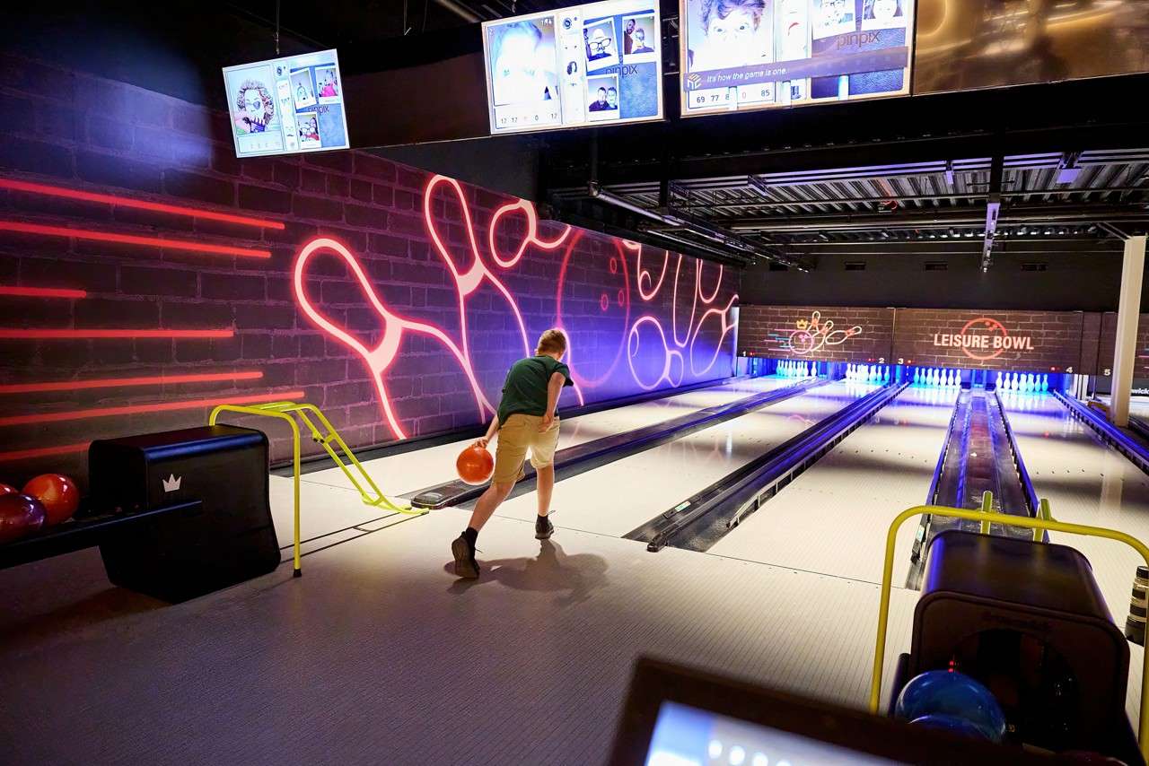 Person bowling a ball inside the Leisure Bowl.