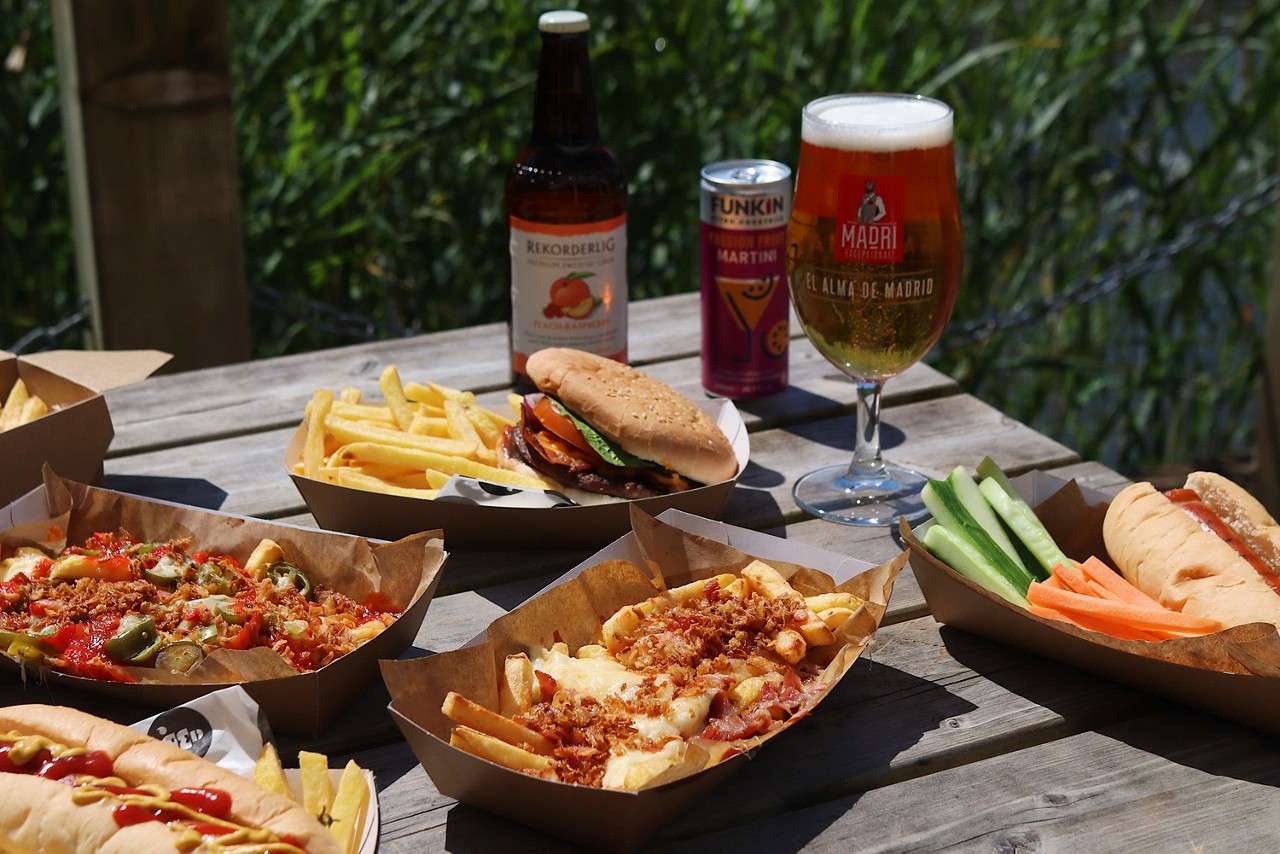 Stacked burger served with fries and a dip.