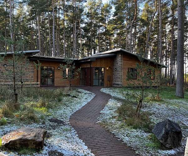 A snowy path leading up to a lodge