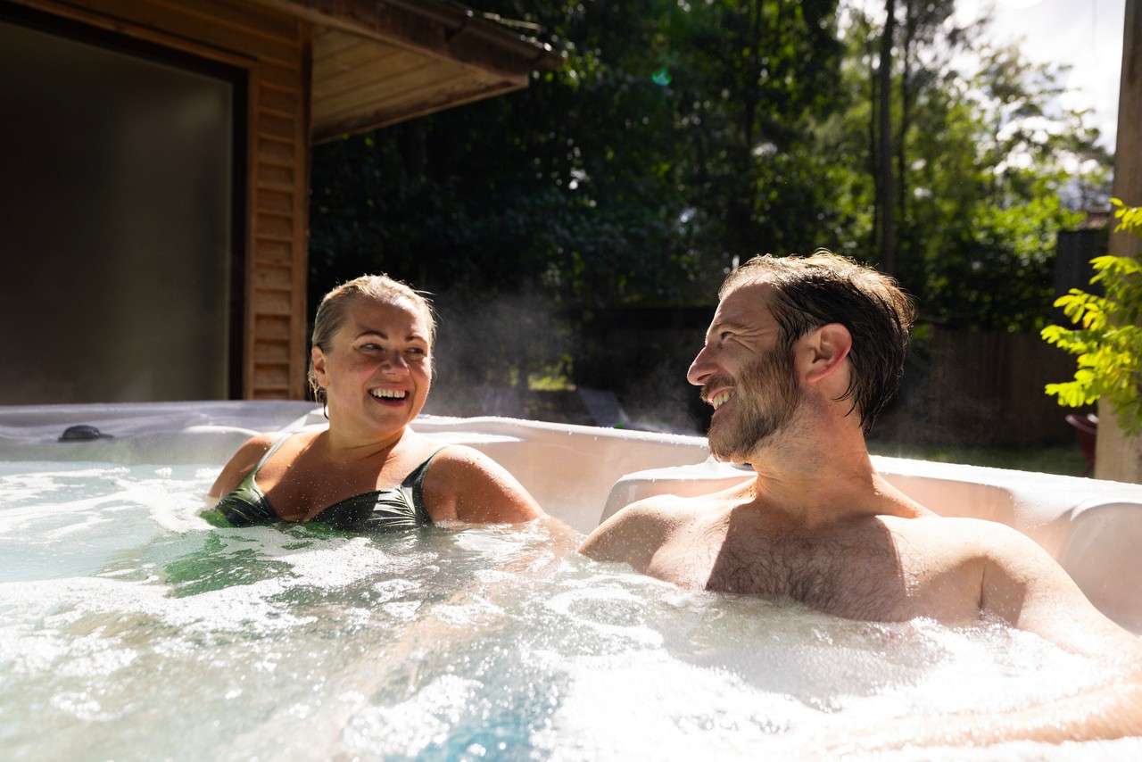 A couple sat together in a hot tub.