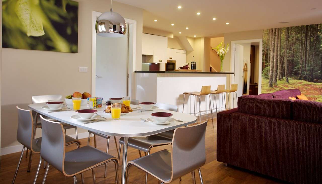 The dining table and living area inside an Executive Lodge