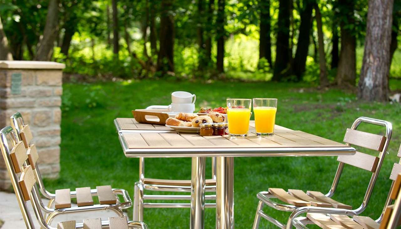 A table laid for breakfast on the patio outside of an Executive Lodge 