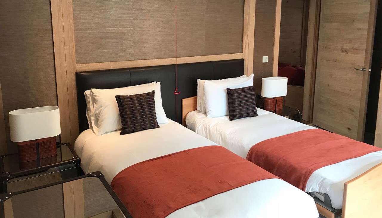 A twin bedroom showing freshly made twin beds