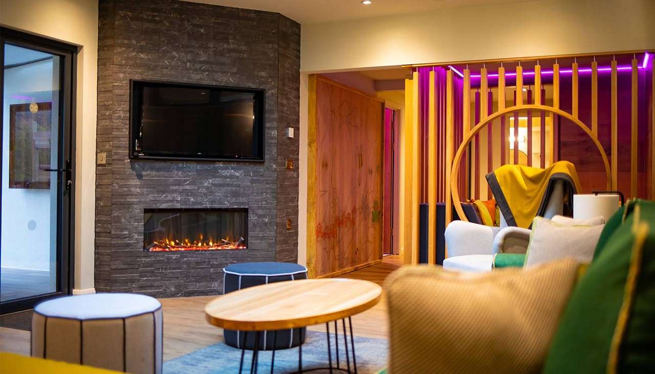 Living area with tv on the wall above the fireplace.