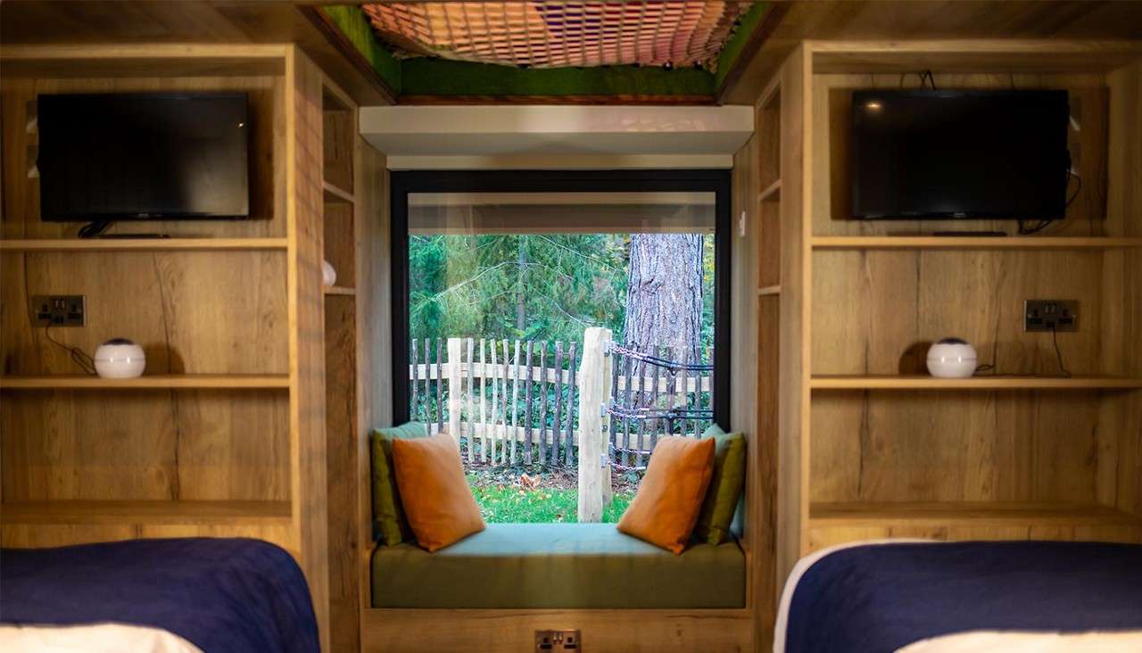 Twin children's bedroom with window and window seat.