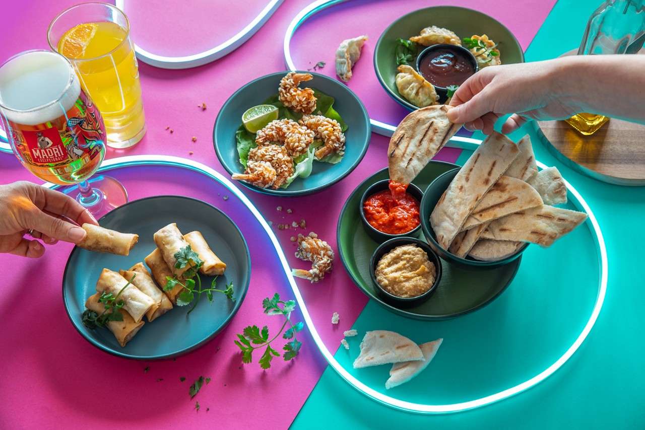 Sharing dishes including spring rolls, flatbreads and breaded prawns.