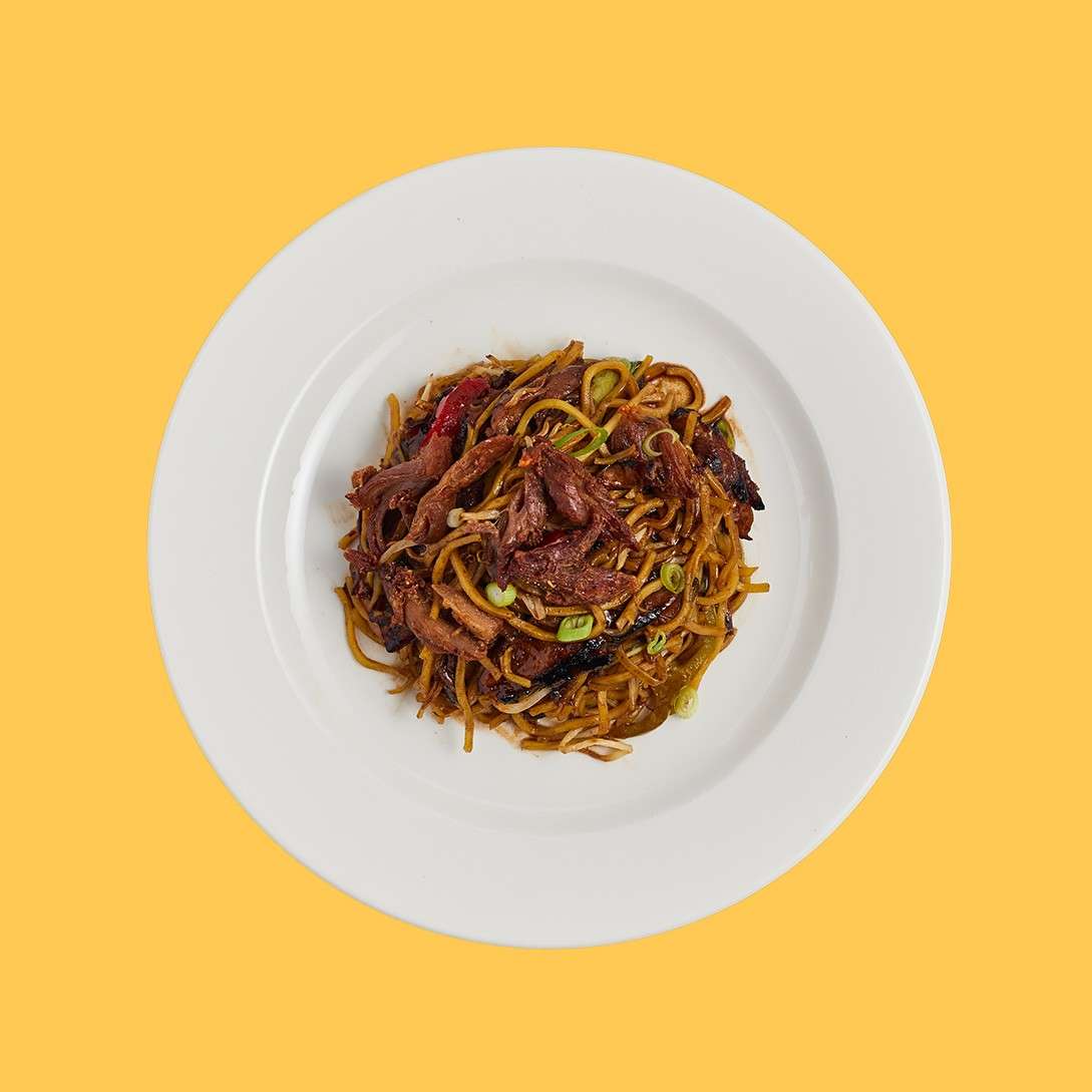 Egg noodles stir fried with duck, garlic, beansprouts, red and yellow pepper, spring onions, pak choi, finished with hoisin sauce and crispy duck pieces.