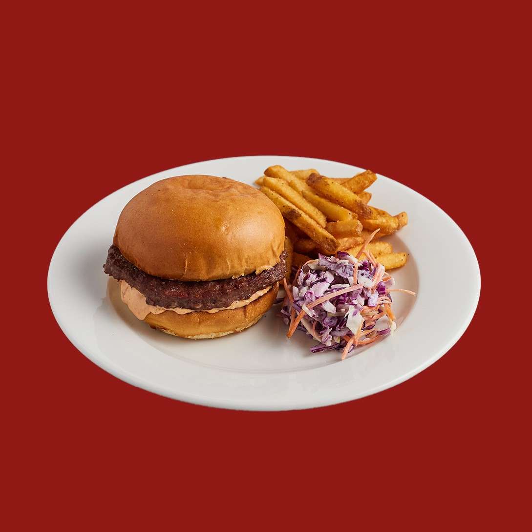 Beef burger in a brioche bun served with fries and slaw.