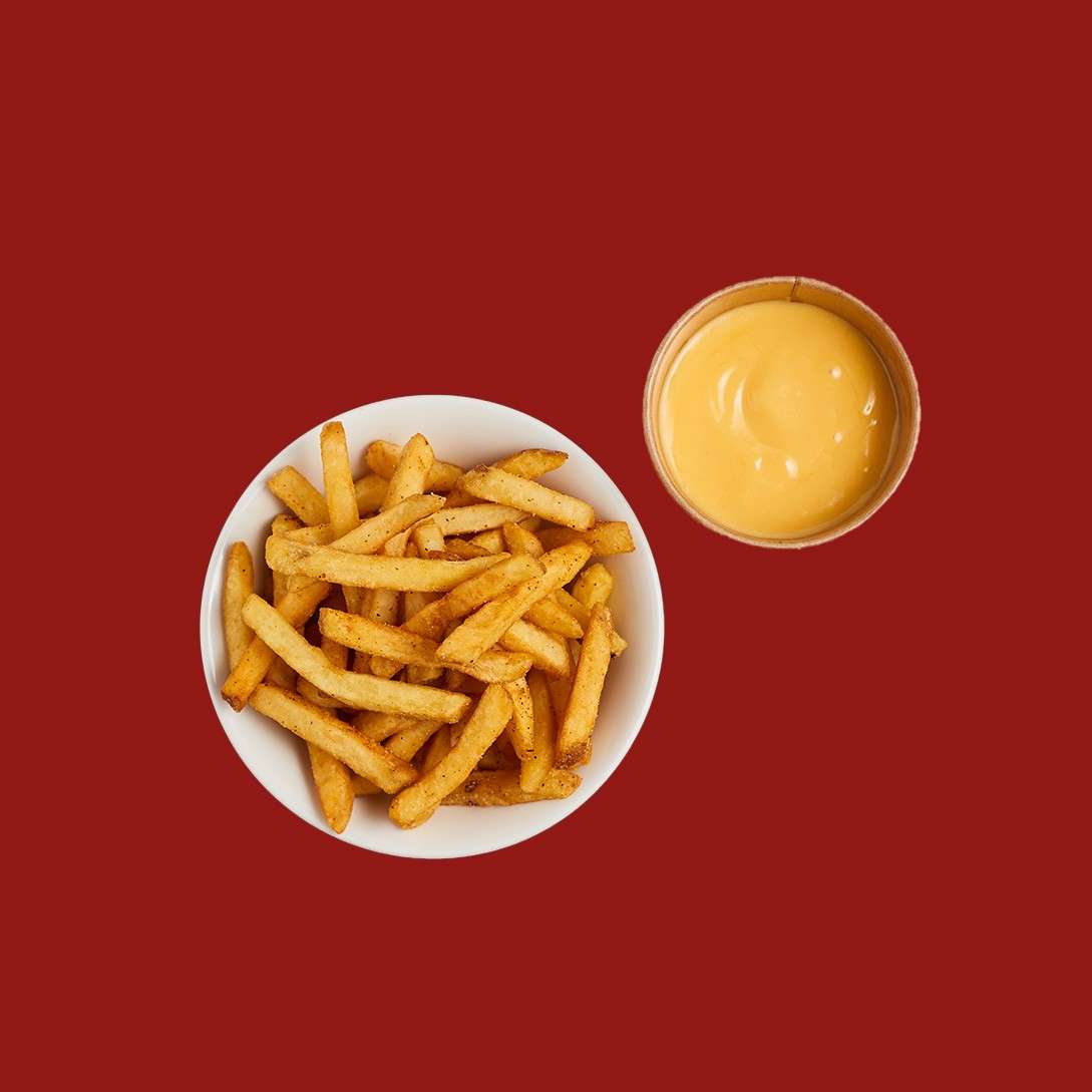 Fries with skin on served with a cheese dipping sauce.