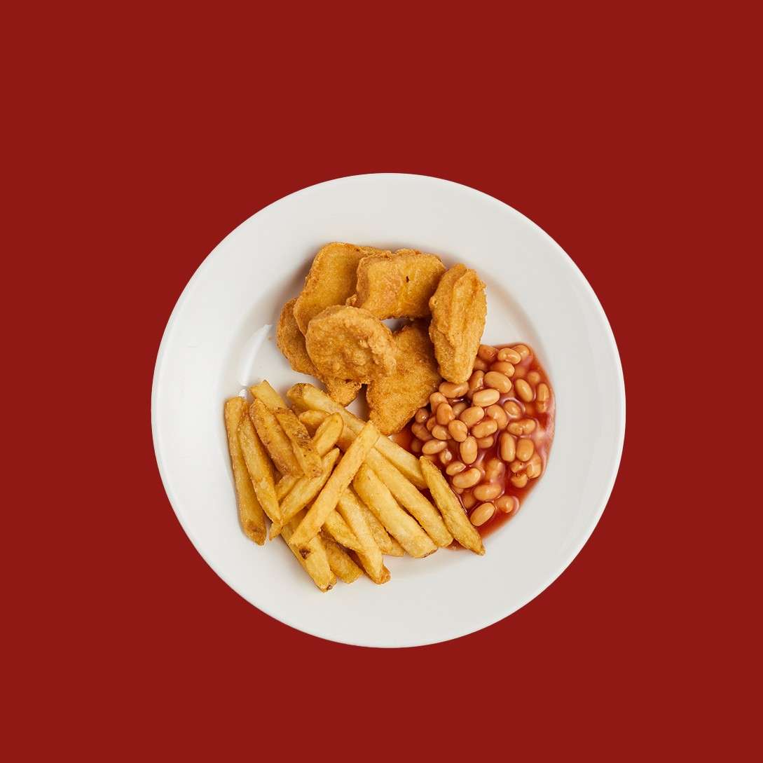 Chicken nuggets served with baked beans and fries.