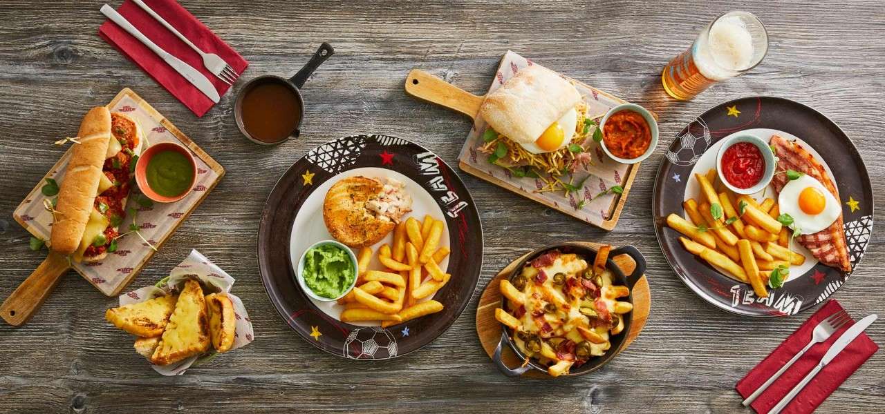 A selection of dishes including a pie and chips, meatball sub, and gammon egg and chips