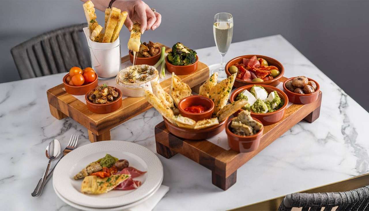 Sharing platter with dips and flatbreads.